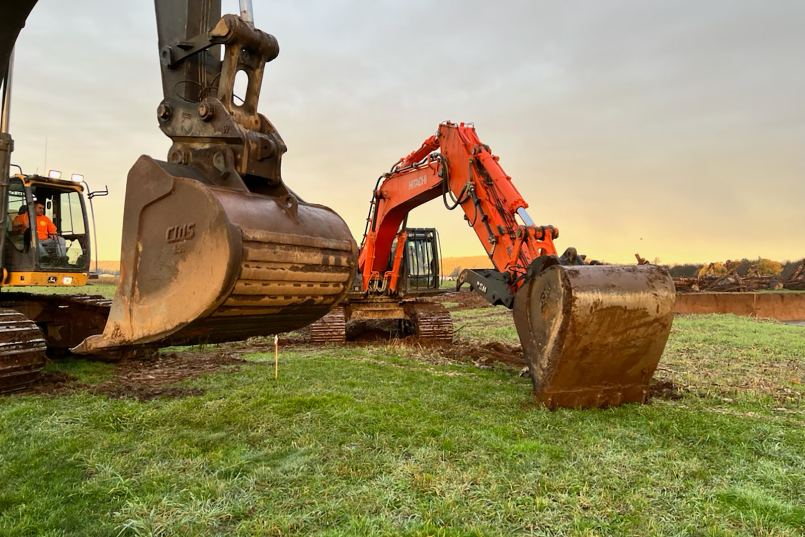 Tractor excavating in field